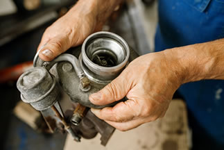 mechanic holding used toyota Avensis engine part